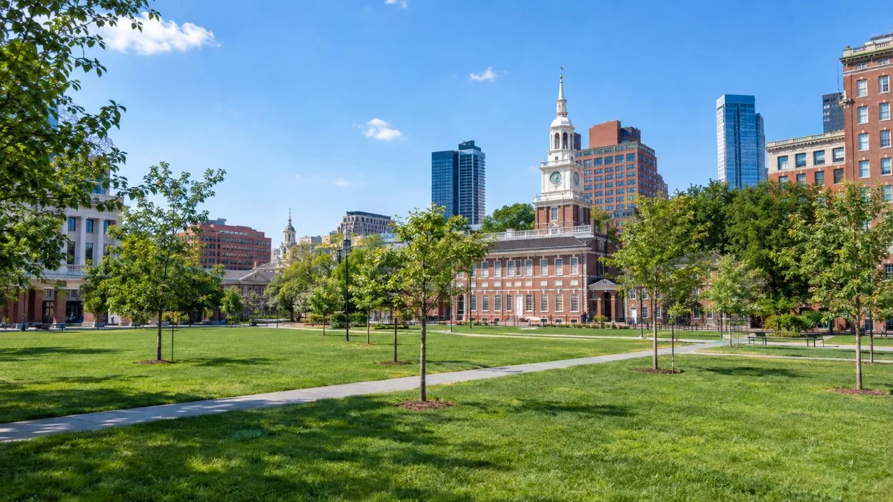 Lawns and paths of Independence Mall with red-brick buildings beyond