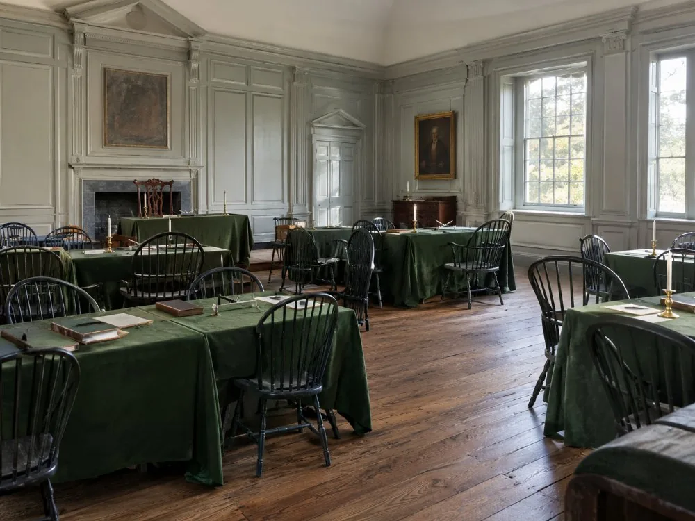 A Georgian assembly room with green tablecloths and Windsor chairs