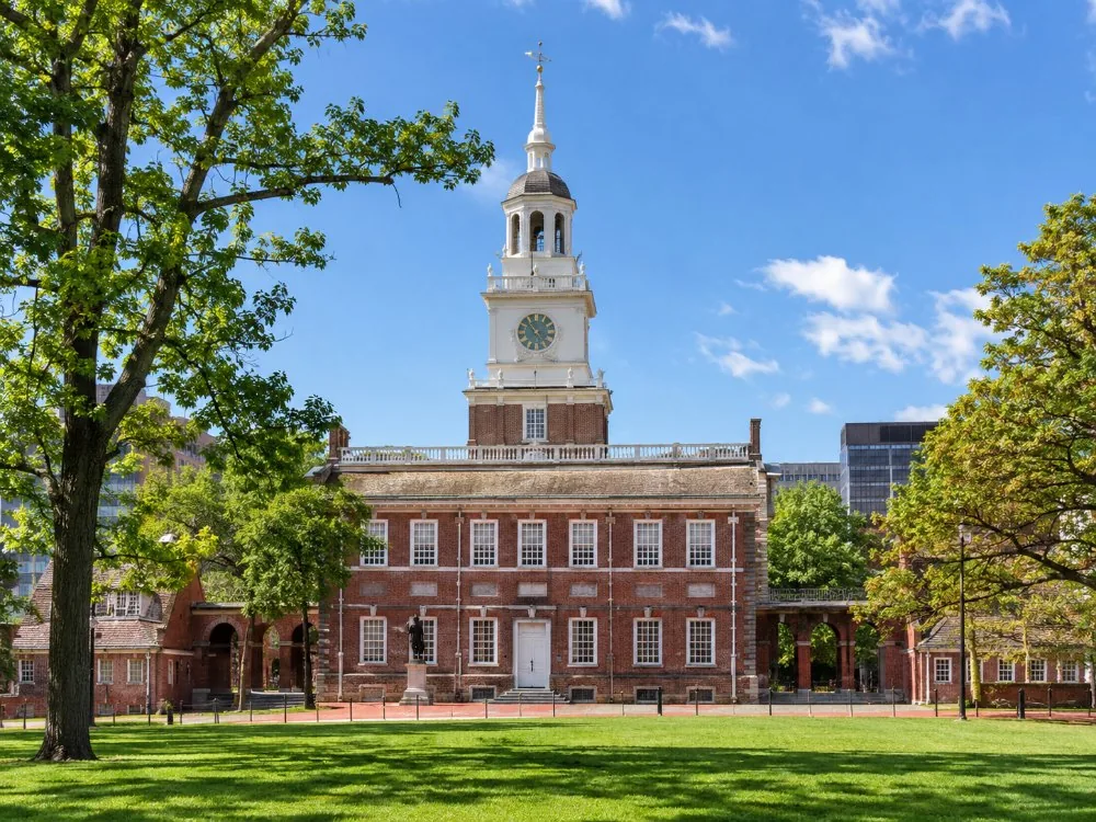 Independence Hall’s red-brick facade and bell tower seen from the lawn